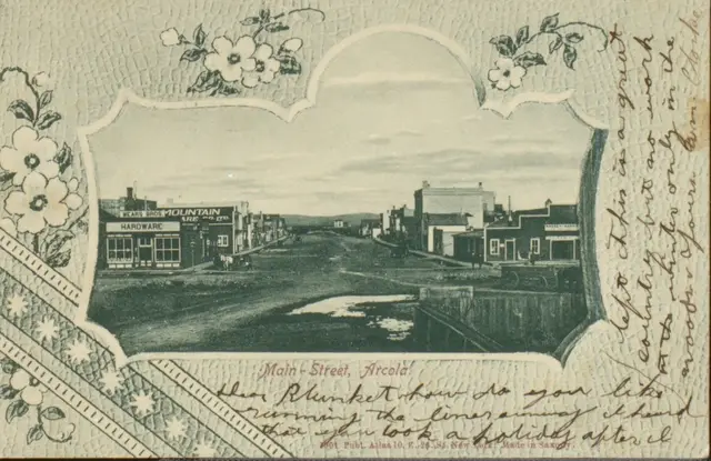 Main Street, Arcola (embossed postcard)